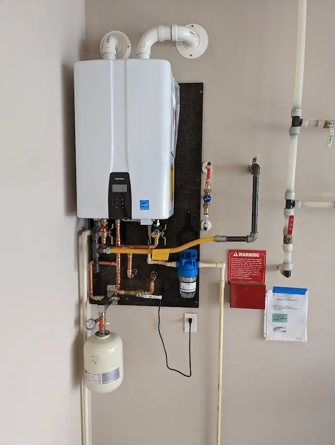 Professional plumber installing copper piping in a Whitehall home